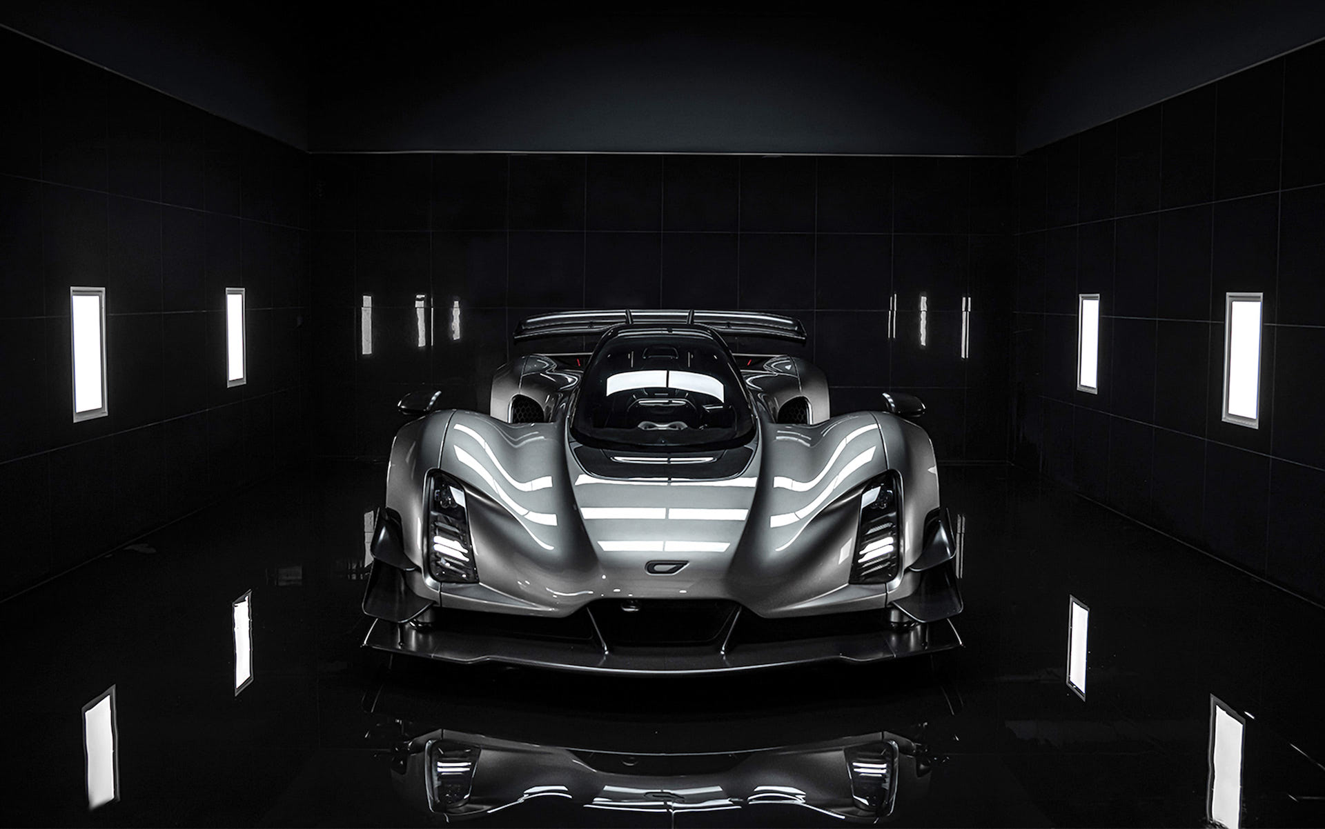 A Czinger 21C sports car in a dark room